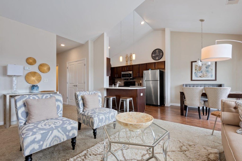 a living room and kitchen with a table and chairs