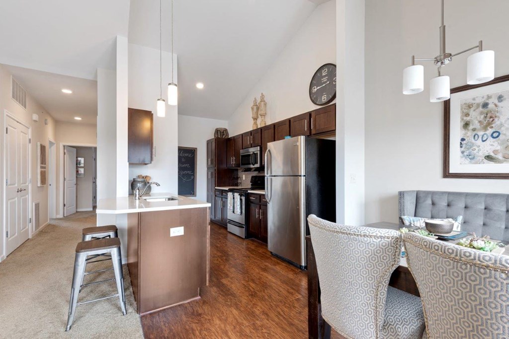a kitchen and dining room with stainless steel appliances