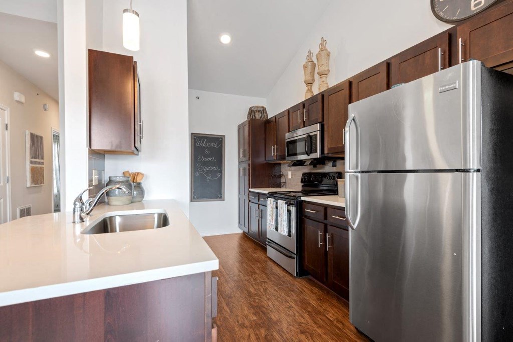 a kitchen with stainless steel appliances and wooden cabinets