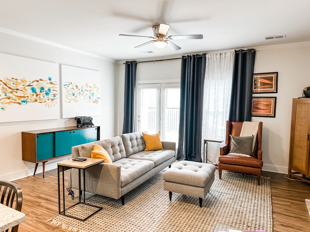 a living room with a couch and a chair and a table