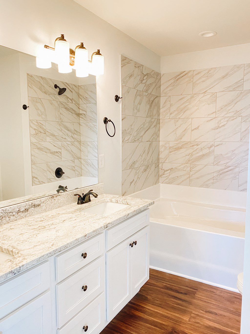 a bathroom with a sink and a tub and a mirror