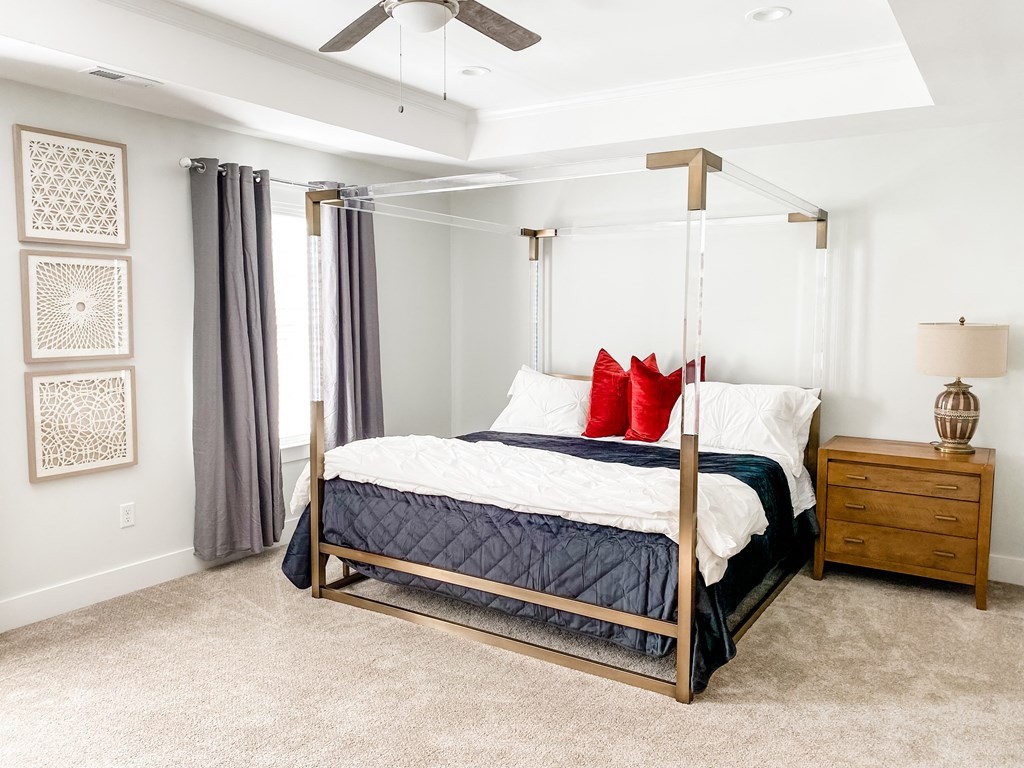 a bedroom with a bed and a ceiling fan