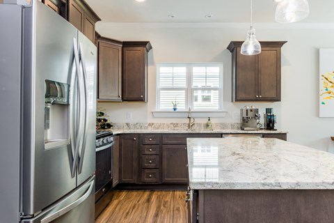 a kitchen with stainless steel appliances and marble counter tops