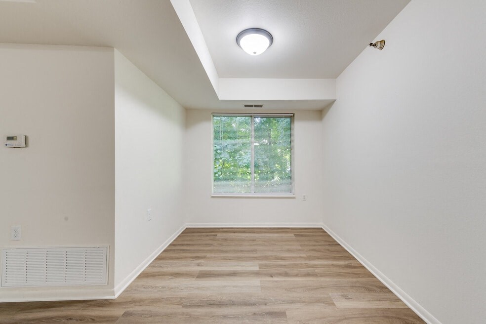 a room with white walls and a window