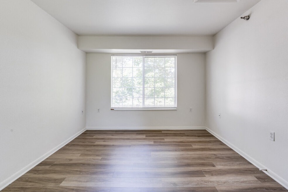 an empty room with white walls and a window