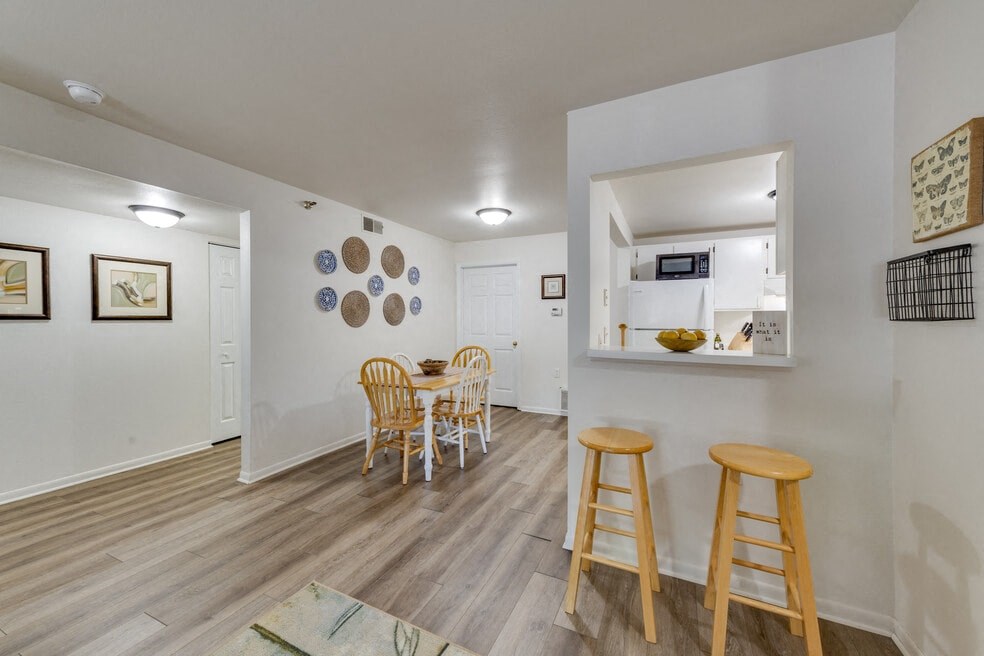 a dining room with a table and chairs and a kitchen