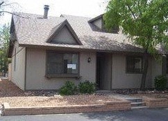 a white house with a sidewalk in front of it