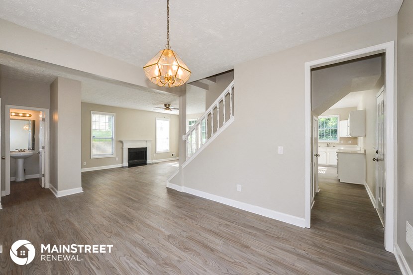 the living room and dining room of a renovated house