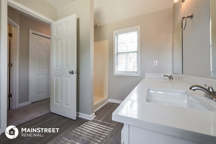 a white bathroom with a sink and a mirror