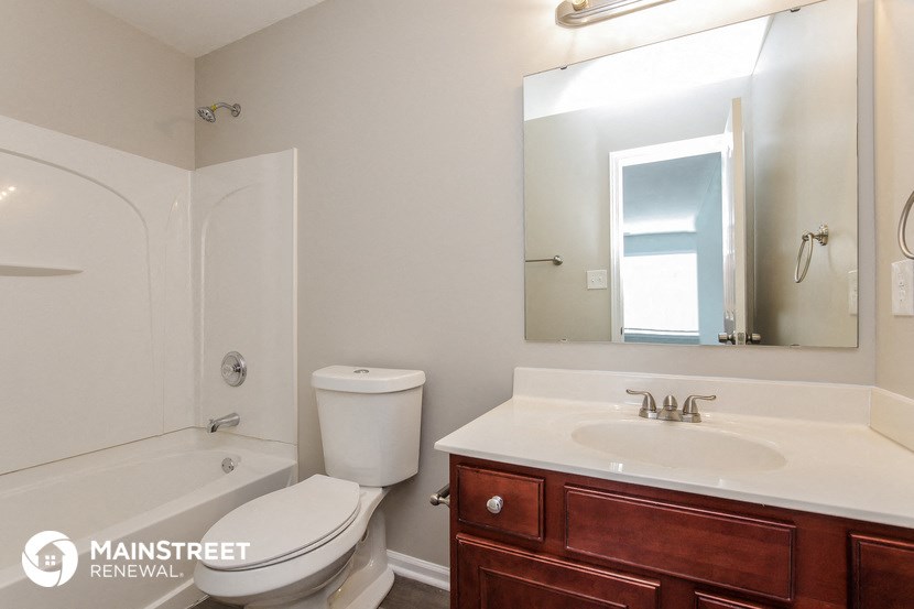 a bathroom with a sink toilet and a mirror and a shower