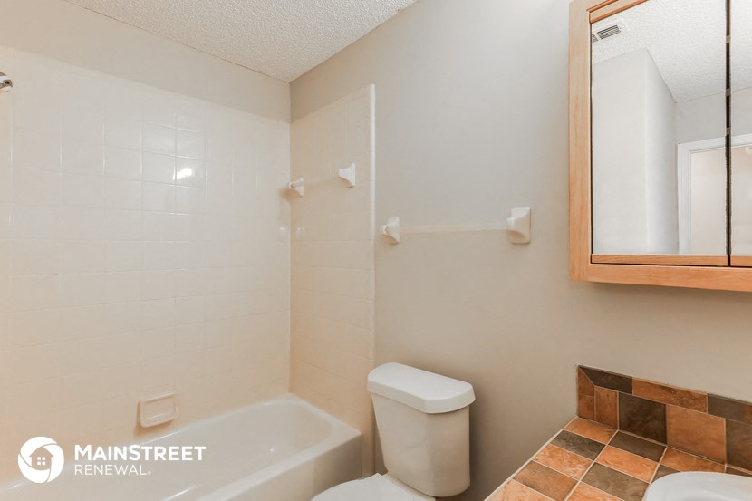 a bathroom with a tub and a toilet and a sink