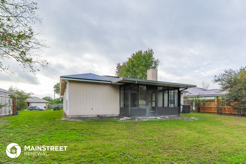 a small house with a yard in front of it