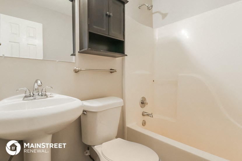 a bathroom with a sink toilet and a shower