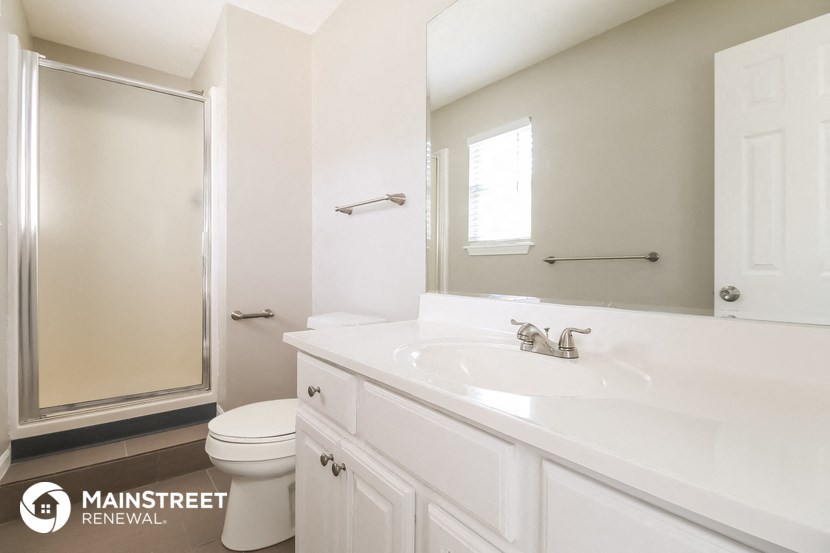 a bathroom with a sink and a toilet and a shower