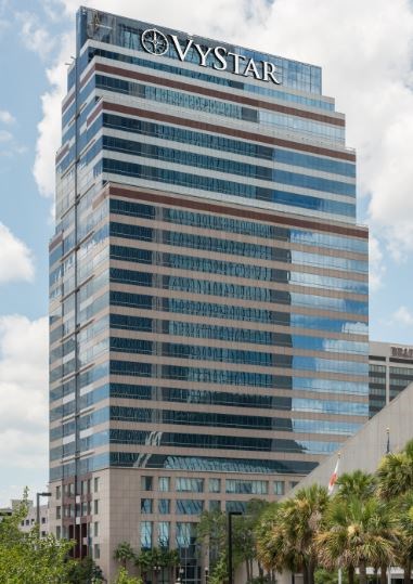 a tall building with palm trees in front of it