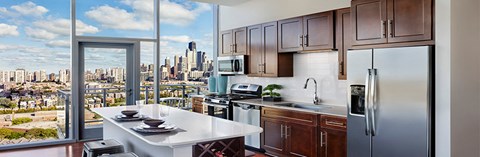 an apartment kitchen with a view of the city
