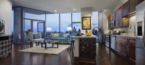 a living room with a kitchen and a city view