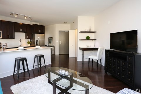 an open living room with a kitchen and a television