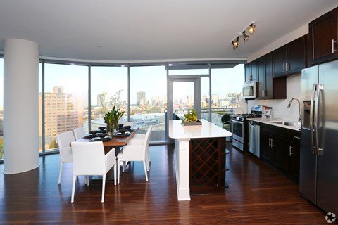 a kitchen and dining room with a view of the city
