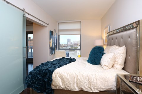 a bedroom with a large bed and a window