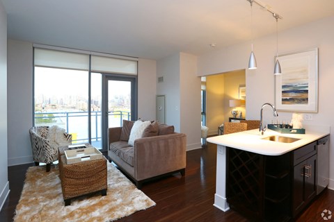 a living room with a couch and a table and a kitchen