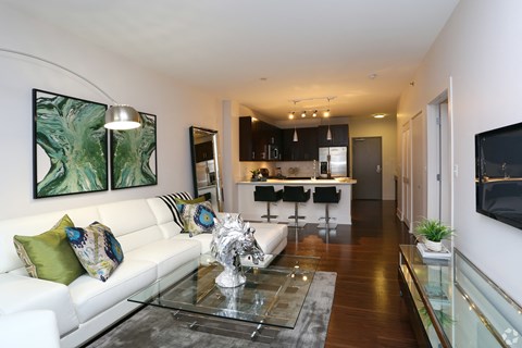 a living room with a white couch and a glass table