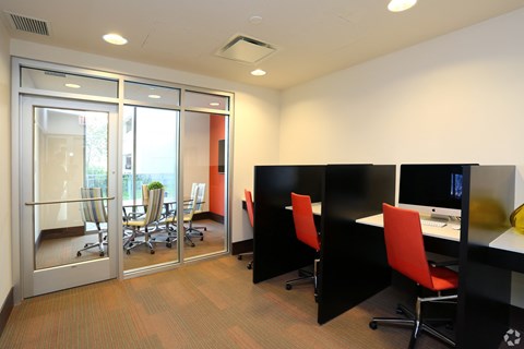 a conference room with desks and chairs and a sliding glass door