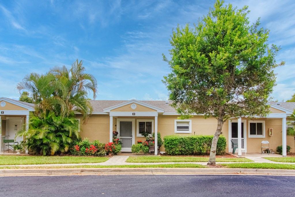 Beautiful villas with mature trees, neat sidewalks, and tropical flowers