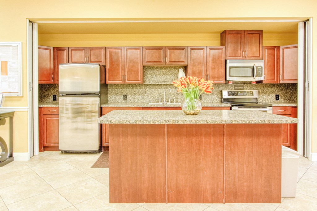 community kitchen with stainless steel appliances, island, and cabinets