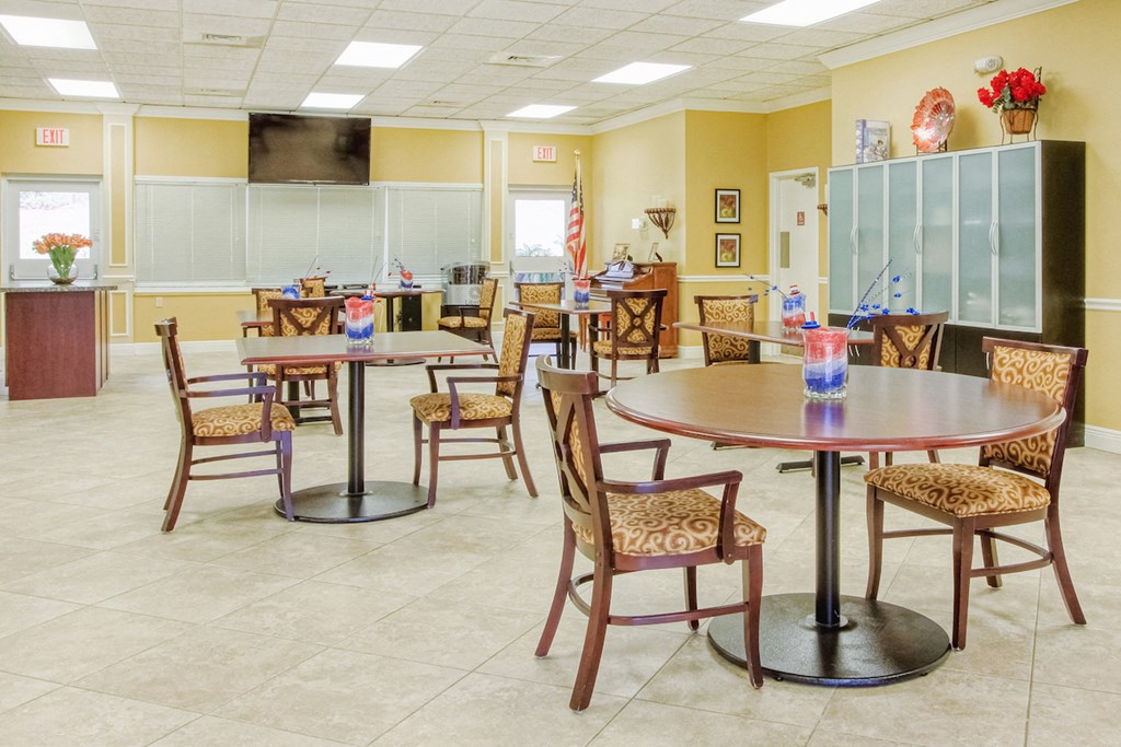 Community room with tables and chairs and TV