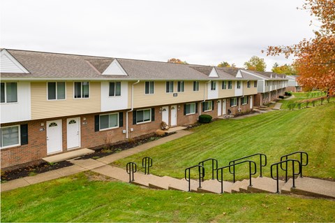 a row of apartment buildings with metal railings