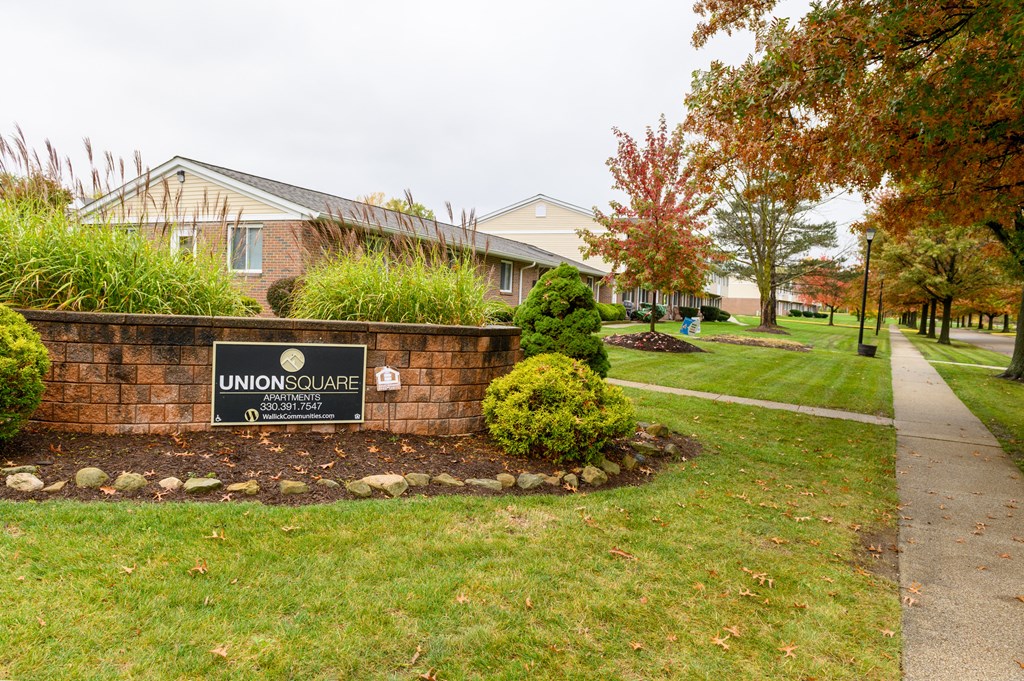 a brick wall with a sign in front of a house