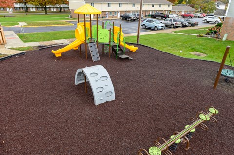 a playground with a slide and other play equipment in a park