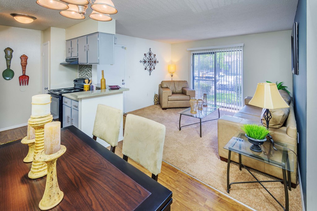 a living room with a kitchen and a dining table