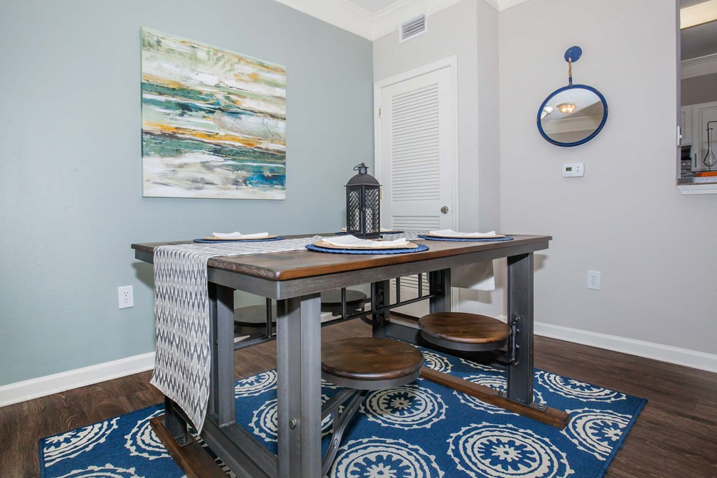 a dining room with a table and two stools