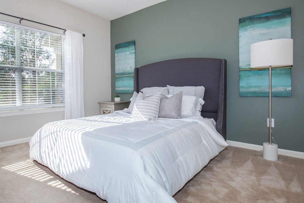 a bedroom with a large bed and a window