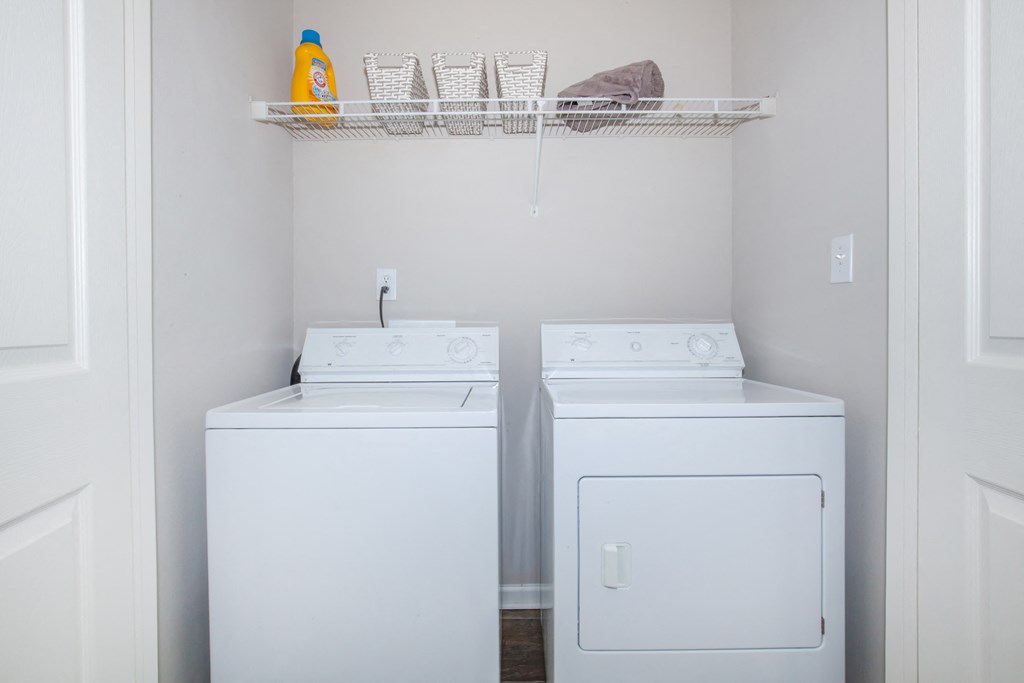 a small laundry room with two washers and a dryer