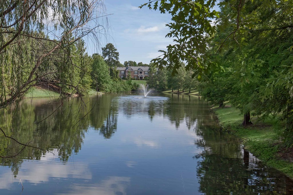 a view of a pond with a fountain in the middle