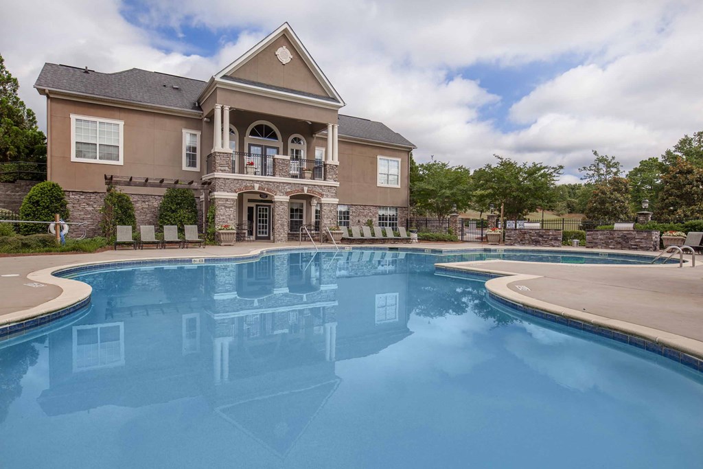 a large swimming pool in front of a house