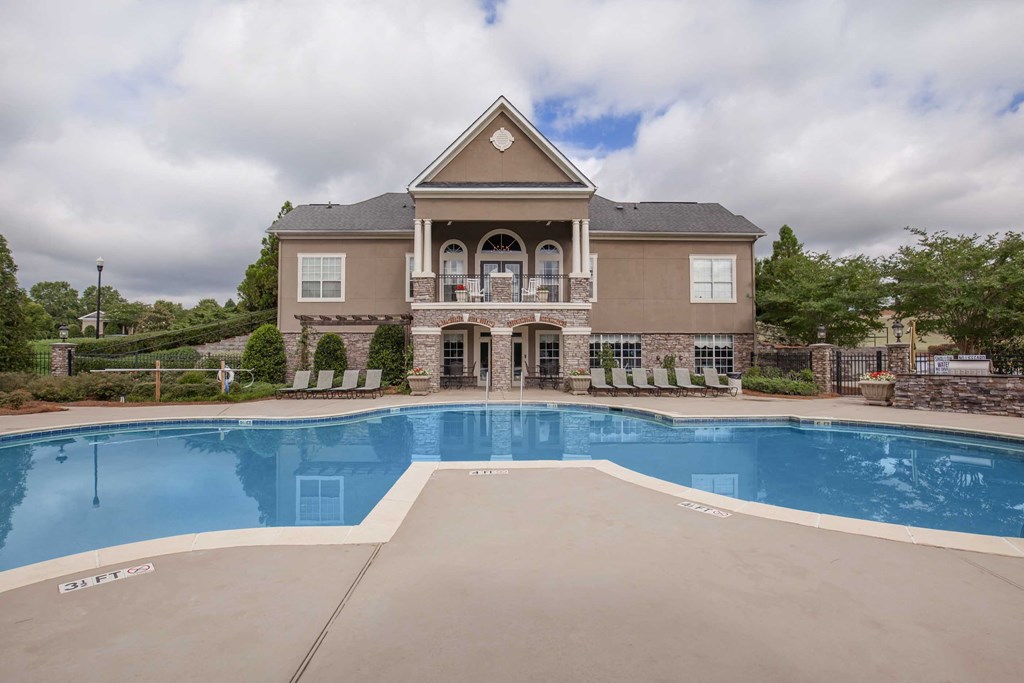 a large swimming pool in front of a house