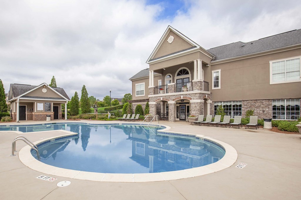 a large swimming pool in front of a house