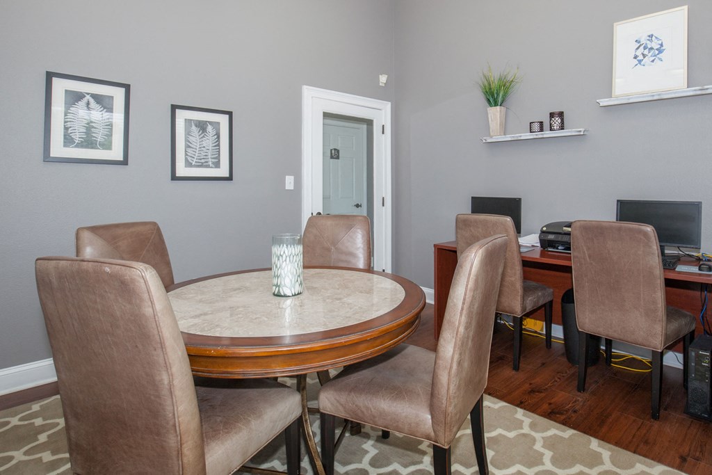 a dining room with a table and chairs and a television