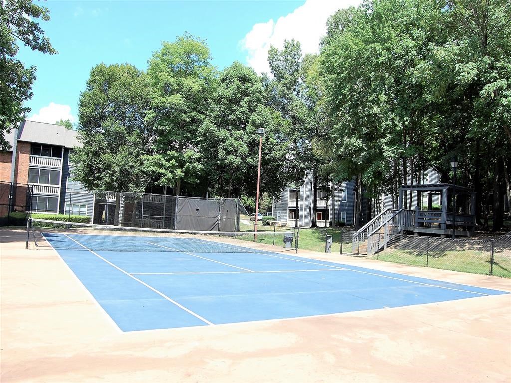 a blue tennis court with a fence around it