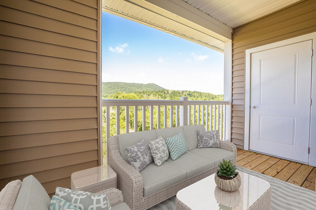 a covered porch with a couch and a table