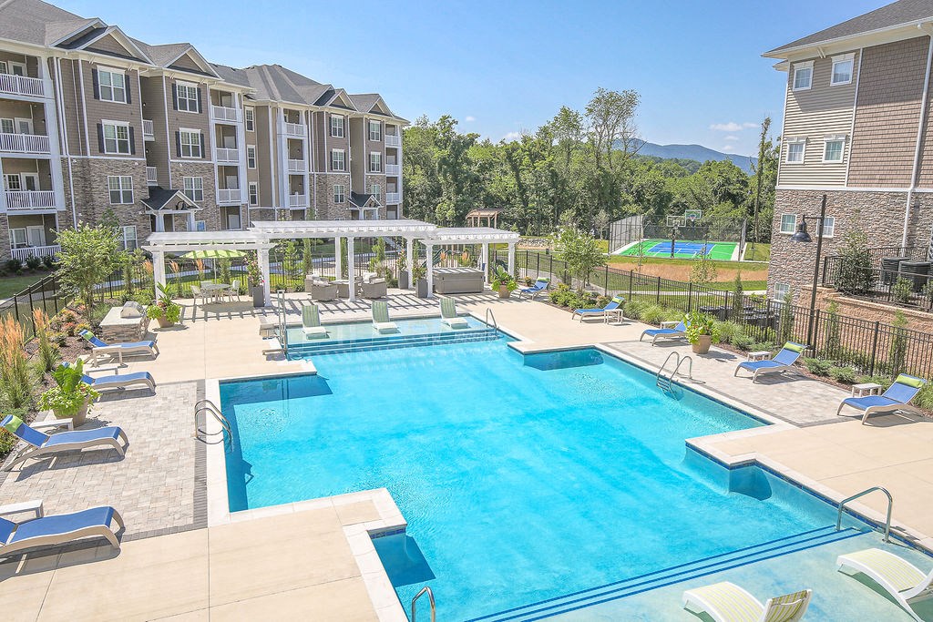 an aerial view of the resort style swimming pool with lounge chairs around it