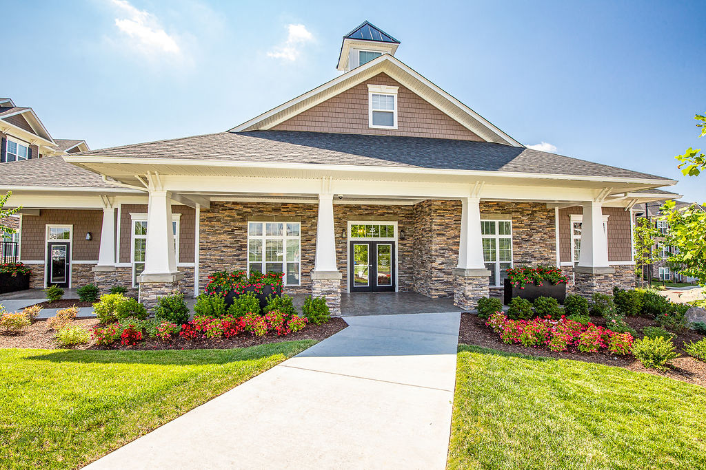 the front entrance to a home with a walkway and landscaping