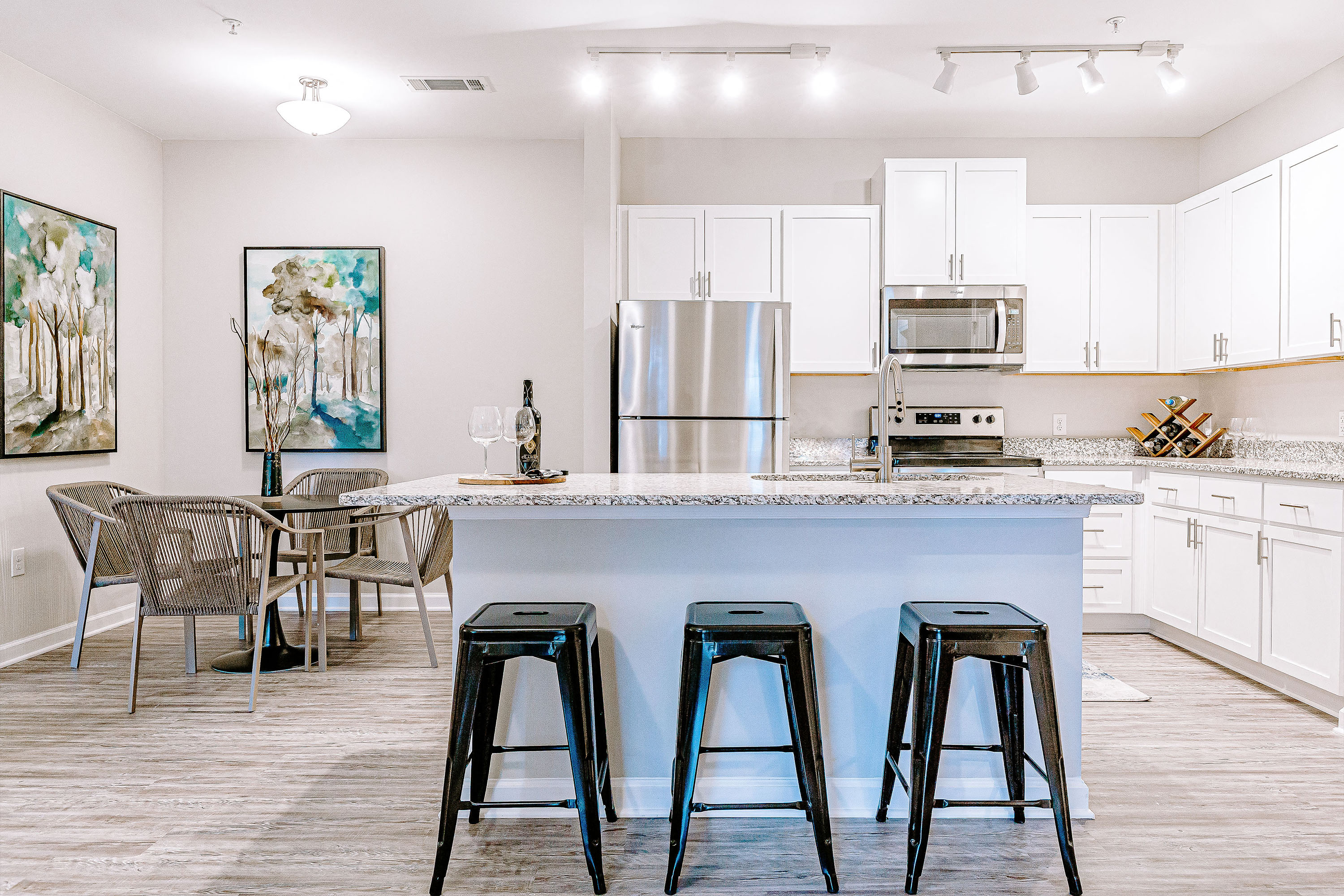a kitchen with a counter top and three stools