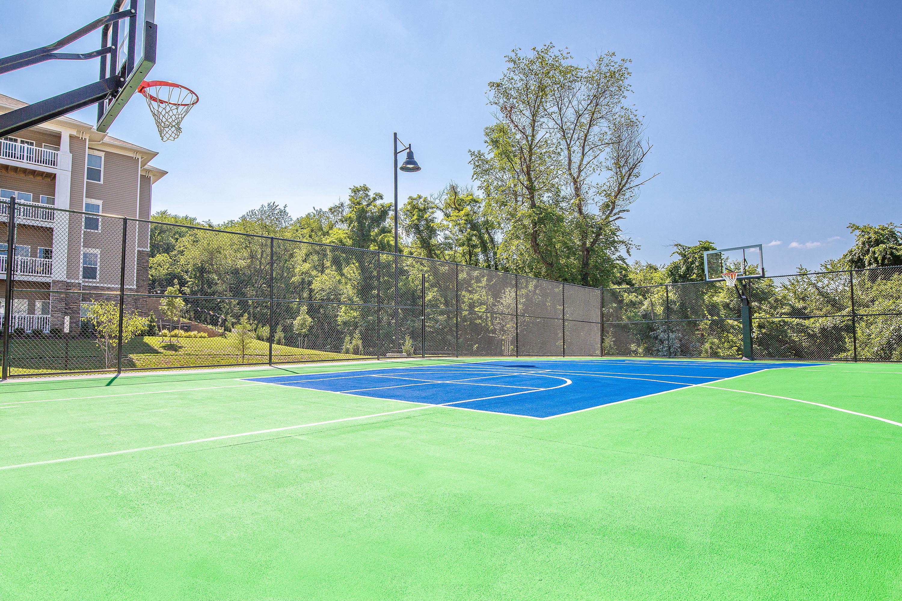 the court is equipped with a basketball court and a basketball hoop on top of it