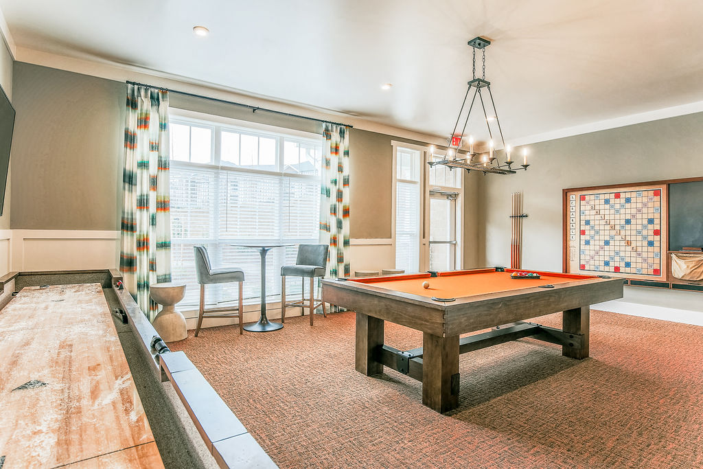 a game room with a pool table and a large window