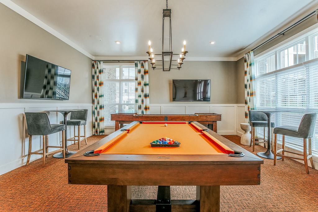 a game room with a pool table and a television